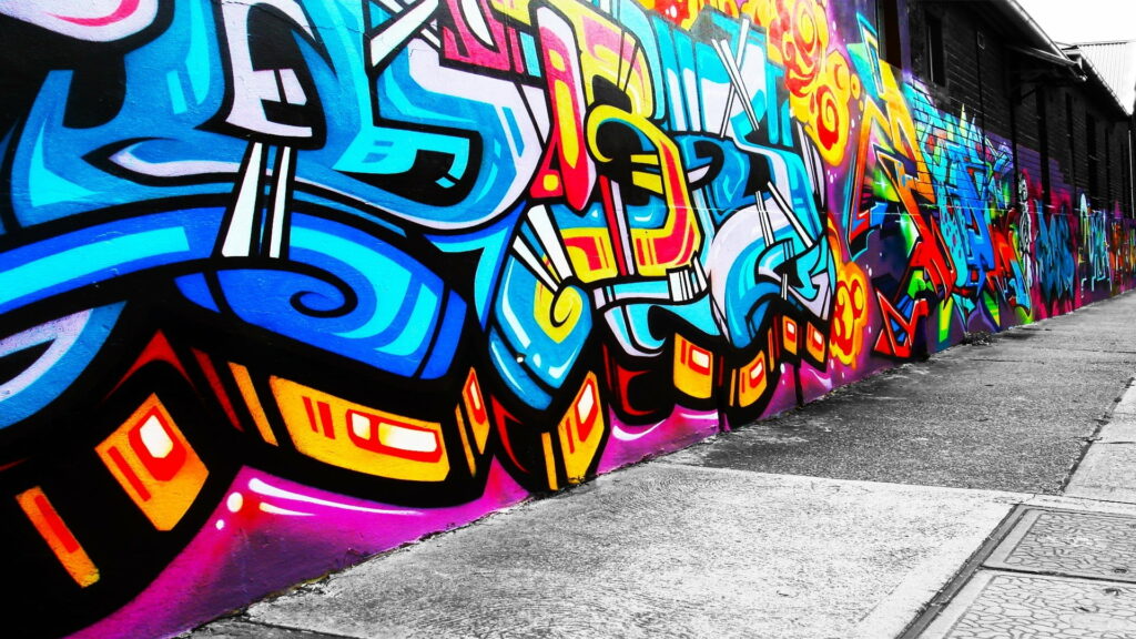 Spray-painted Masterpiece: Captivating Wall Graffiti as an HD Wallpaper Background