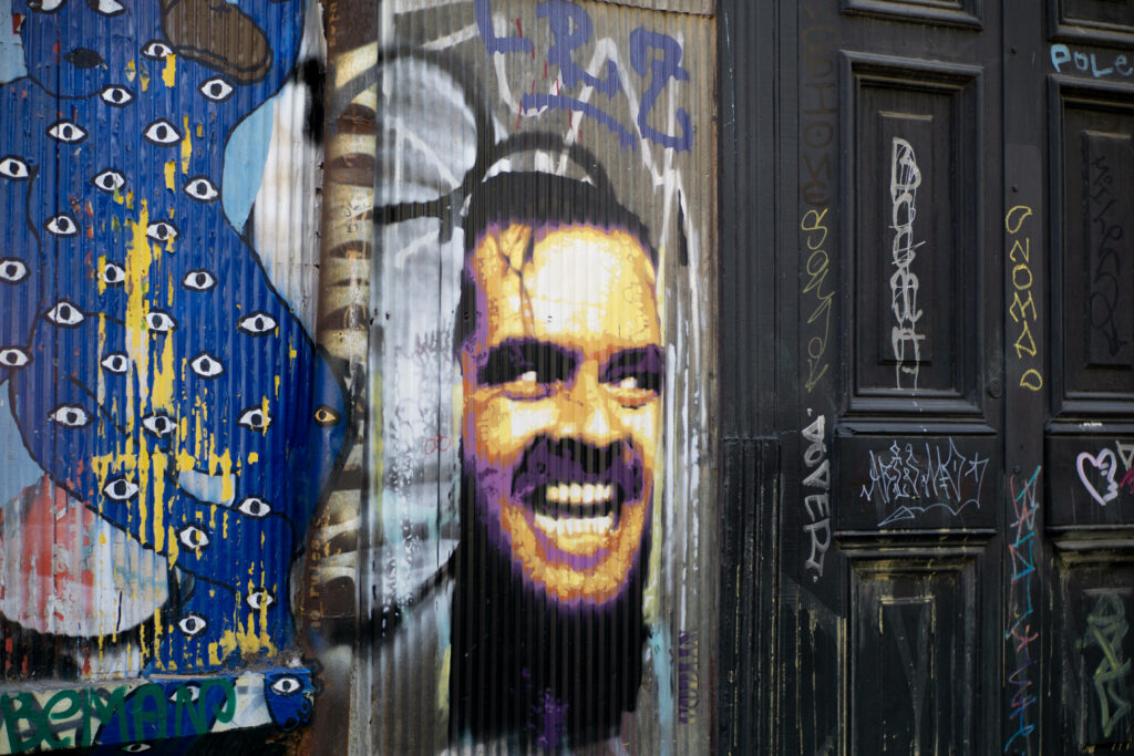 Vibrant The Shining Character Street Art Wallpaper with Graffiti