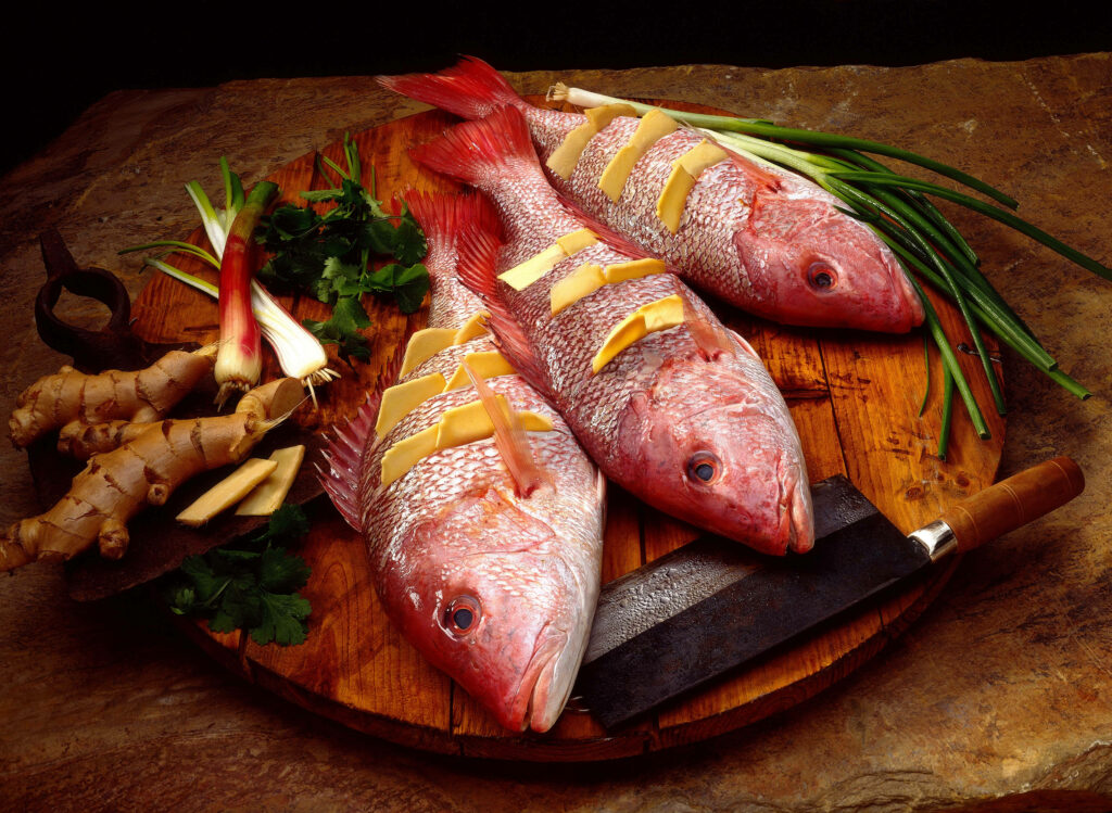Vibrant Stuffed Red Snapper on Rustic Board - Culinary Wallpaper
