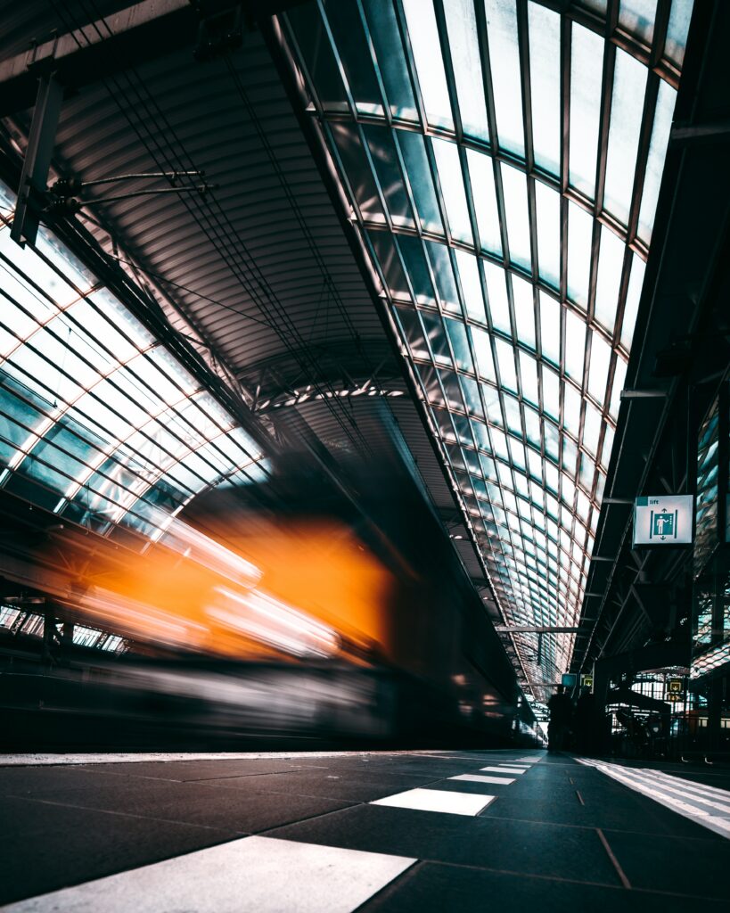 Dynamic Subway Wallpaper: Blurred Train Under Glass Ceiling