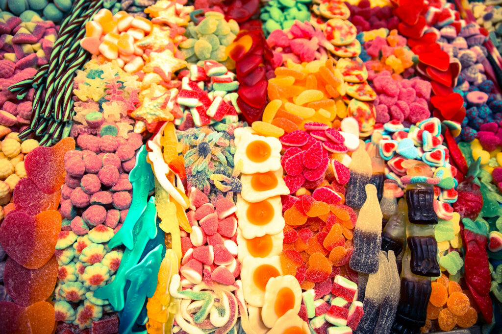 Colorful assorted sugar candies wallpaper with gummies licorice and jelly sweets background