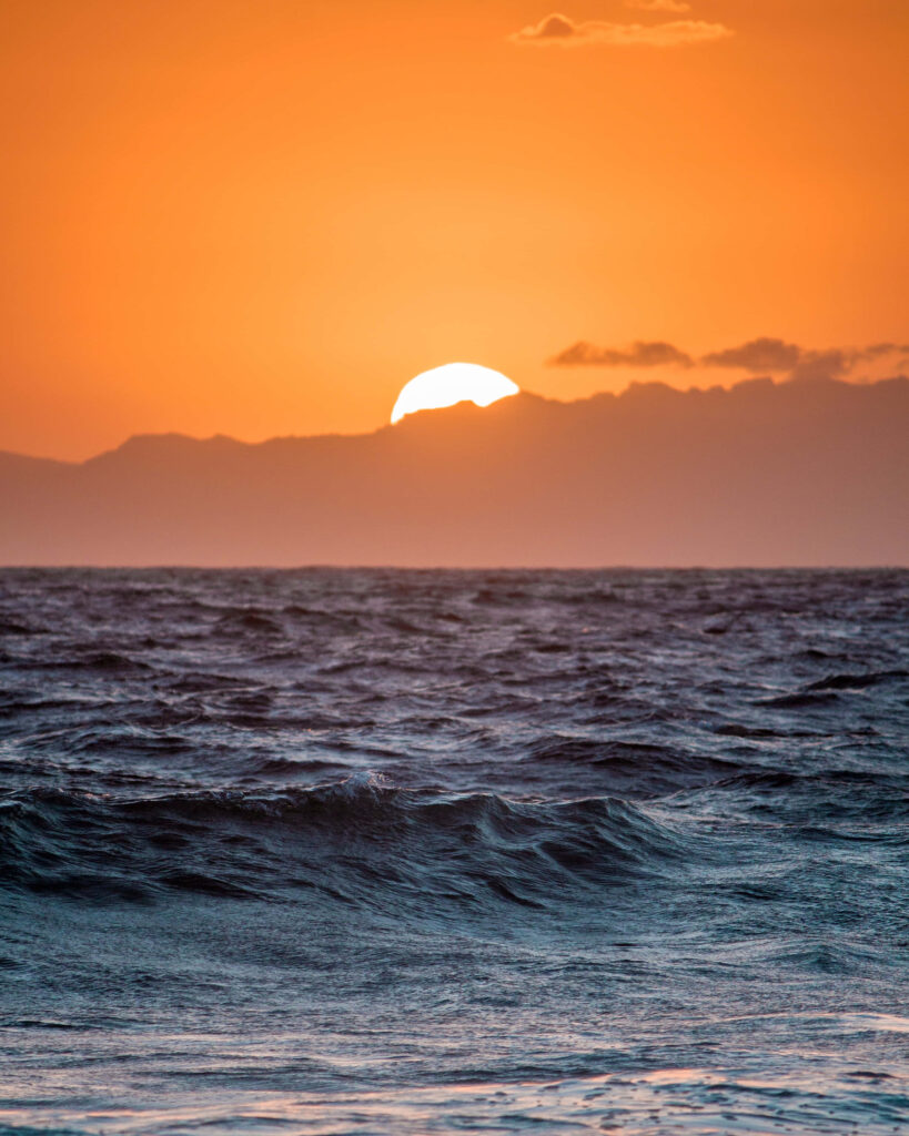 Vibrant Sunset Beach Wallpaper: Serene Mountain View Background