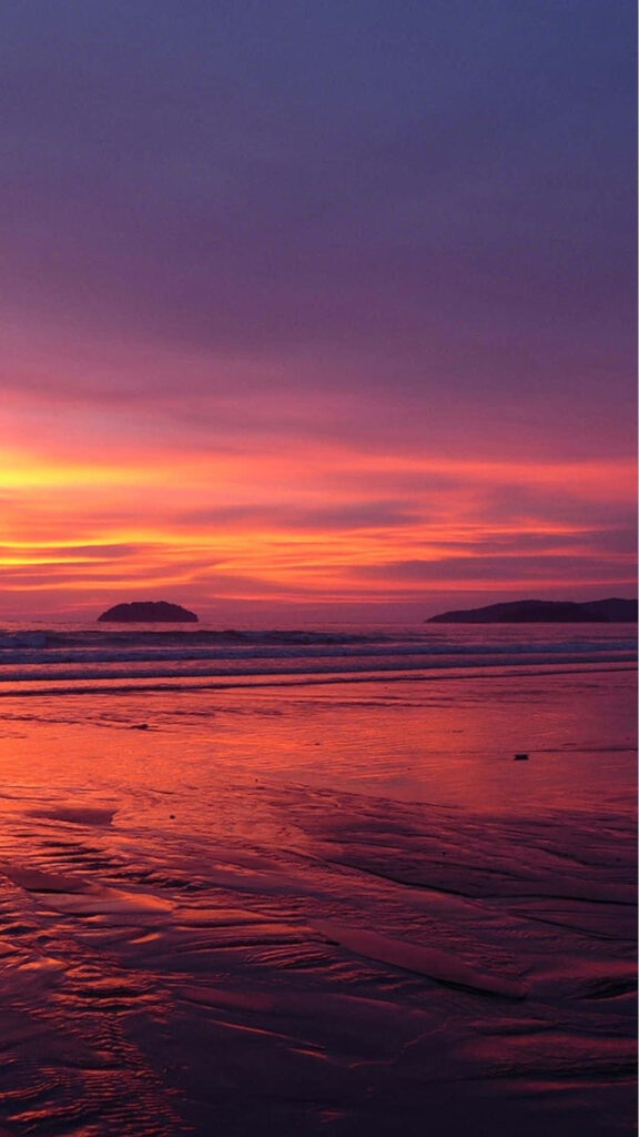 Vibrant Sunset Beach Wallpaper: Serene Orange & Purple Reflections