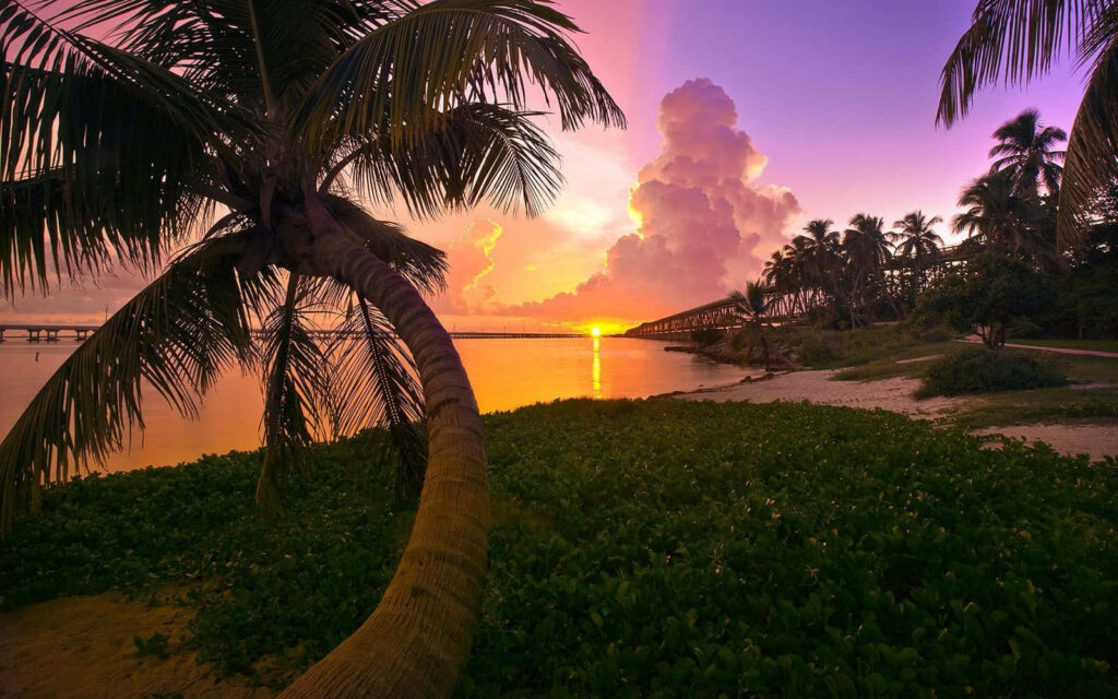 Breathtaking Sunset Over Tranquil Beach: A Serene Island Paradise Wallpaper