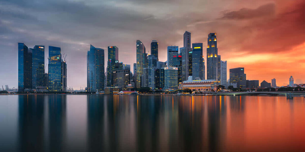 Vibrant Sunset Skyline Wallpaper: Serene City Reflection Background