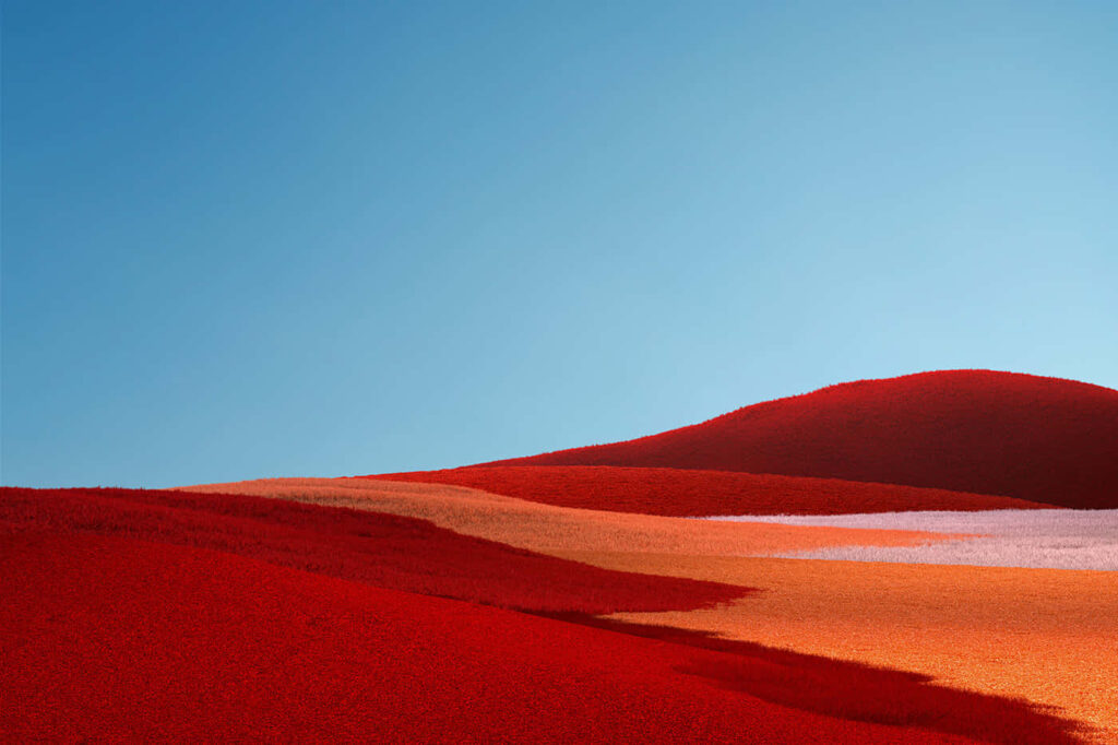 Surreal Vibrant Landscape Wallpaper: Red Hills & Blue Sky Background