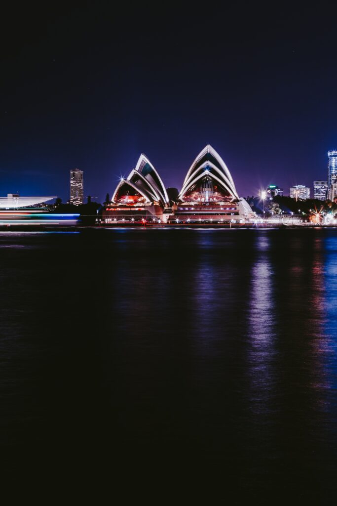 Vibrant Sydney Night Wallpaper: Opera House & City Lights Reflection