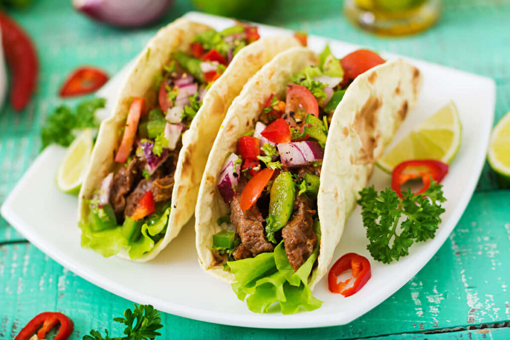 Vibrant Taco Plate with Fresh Veggies & Lime - Colorful Wallpaper