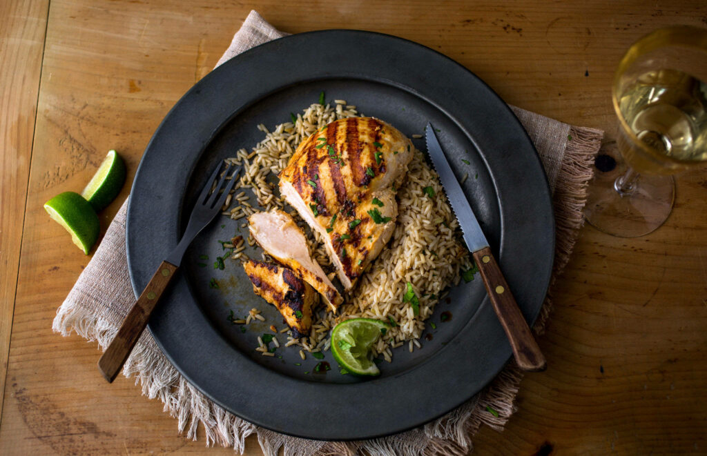 Vibrant Tandoor Chicken Dish with Savory Rice and Lime Wallpaper