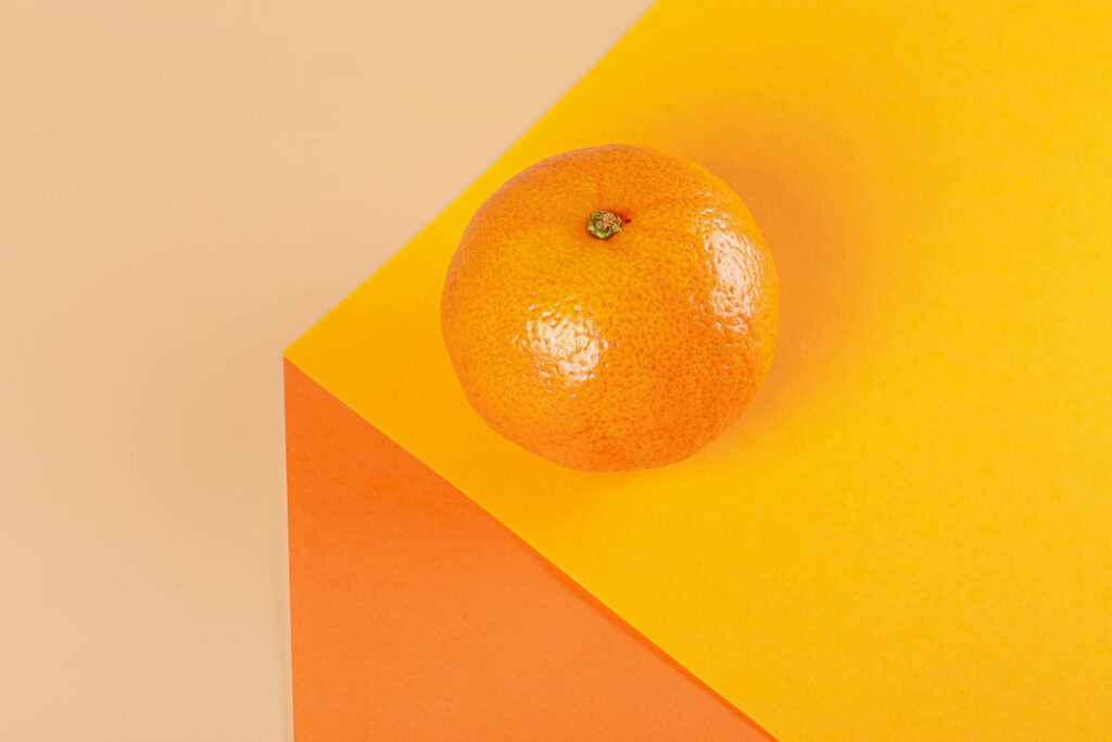 Vibrant Tangerine Wallpaper: Fresh Fruit on Bright Orange Yellow Background