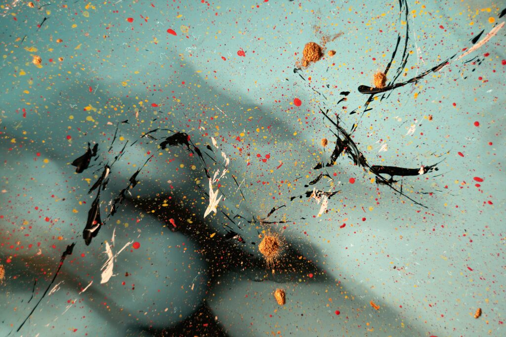 Vibrant Abstract Paint Splash Wallpaper on Teal Background