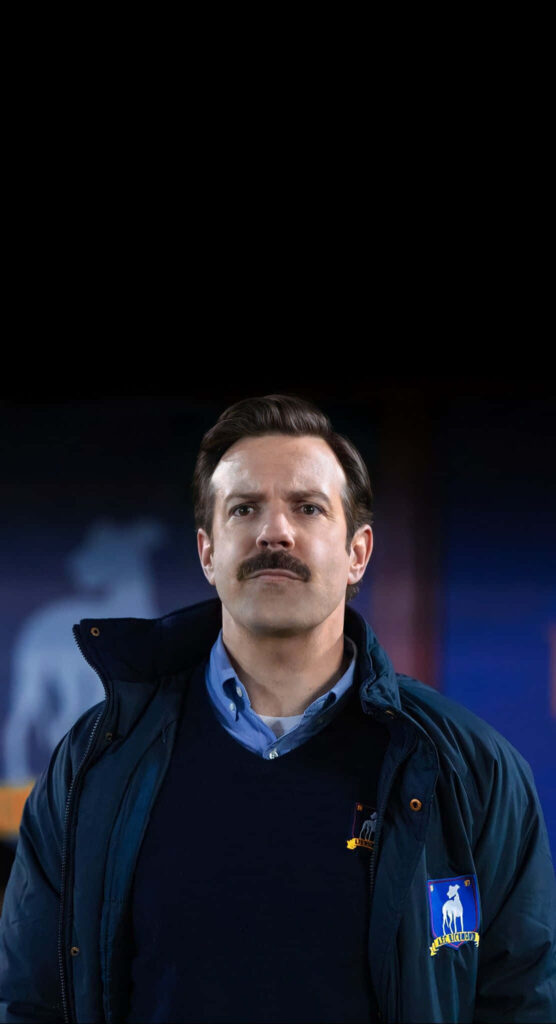 Optimistic Ted Lasso Wallpaper: Heartwarming Stadium Background