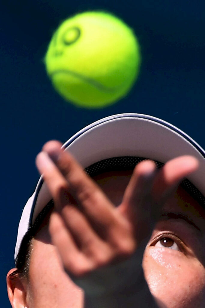 Dynamic Tennis Serve Toss Wallpaper: Shuai Peng in Motion