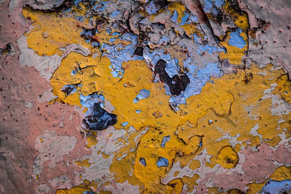 Vibrant Abstract Wallpaper: Textured Peeling Paint in Yellow, Blue, Pink