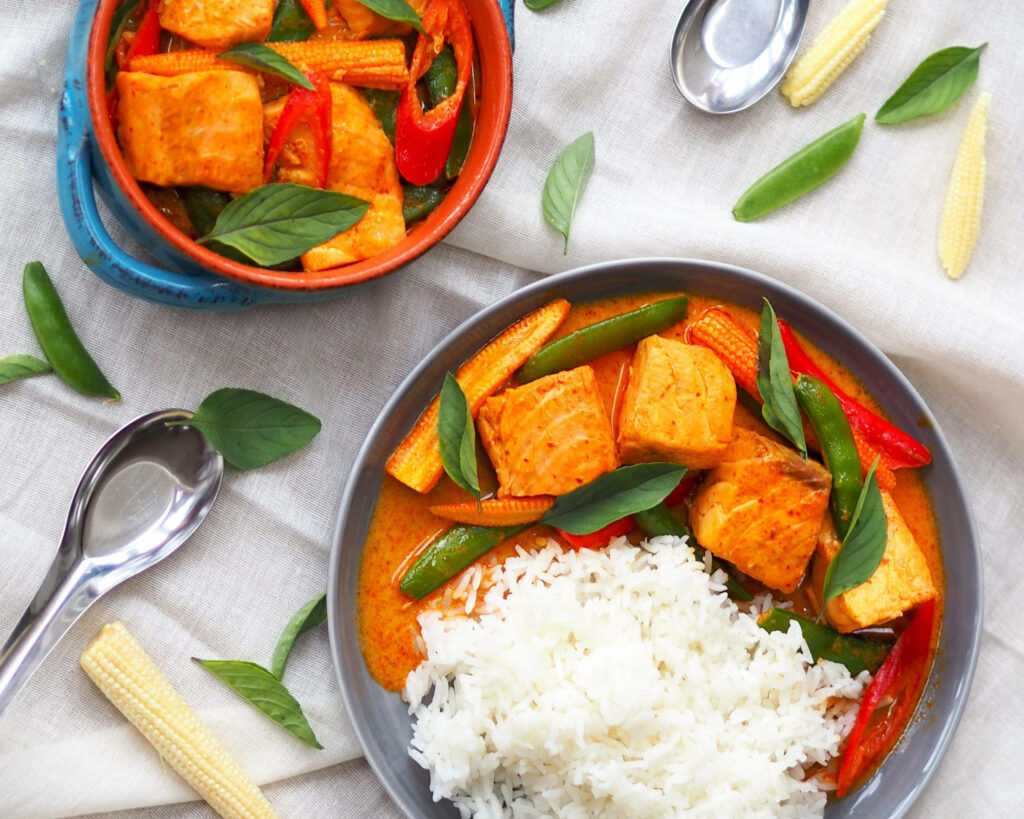 Vibrant Salmon Red Thai Curry Wallpaper with Rice & Veggies