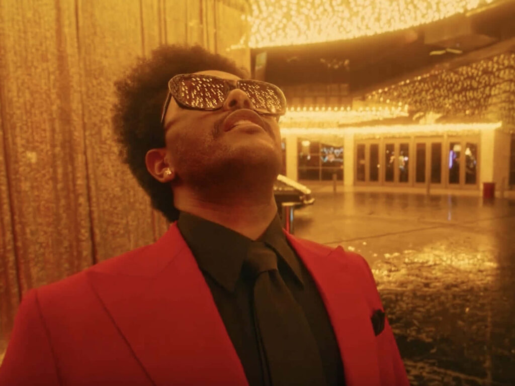 Vibrant Wallpaper of The Weeknd in Red Suit from *After Hours*