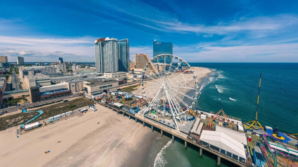 Vibrant Coastal Theme Park Wallpaper: Ferris Wheel & Skyline