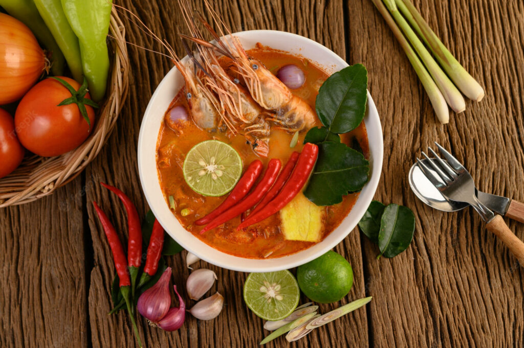 Colorful Tom Yum Soup Wallpaper with Fresh Ingredients