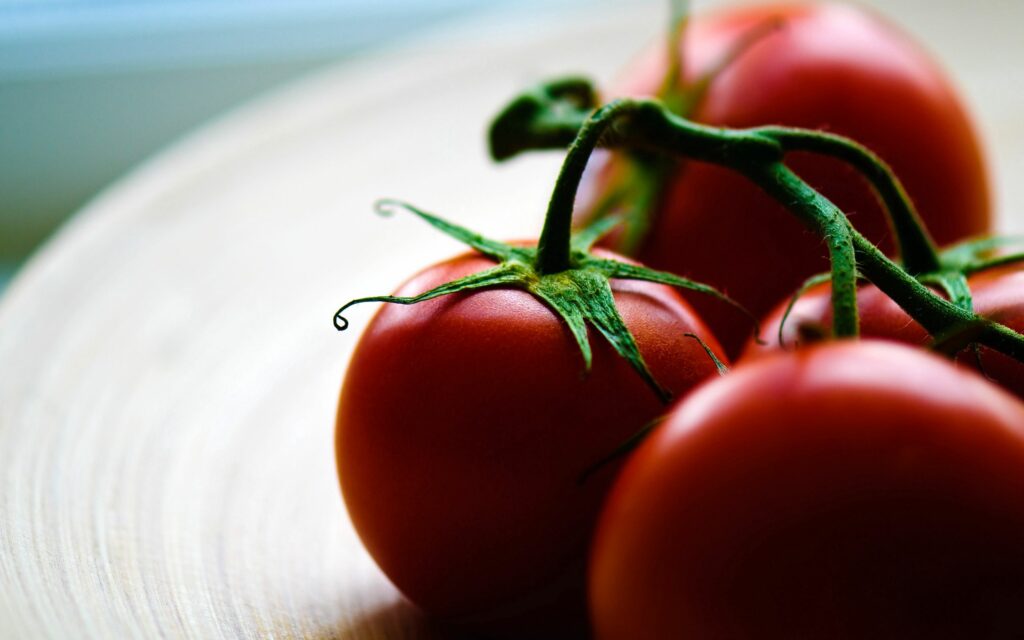 Vibrant Tomato Wallpaper: Ripe Red Tomatoes on Soft Background