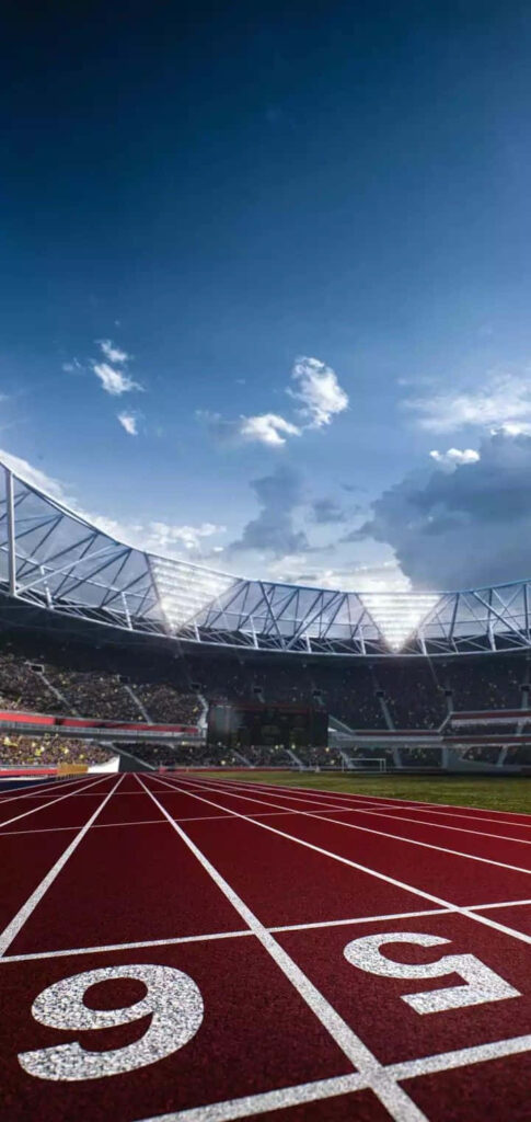 Vibrant Track and Field Stadium Wallpaper Under Clear Sky
