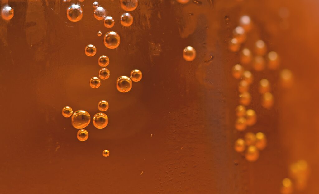 Vibrant Orange Bubbles Wallpaper: Dynamic Liquid Close-Up Background