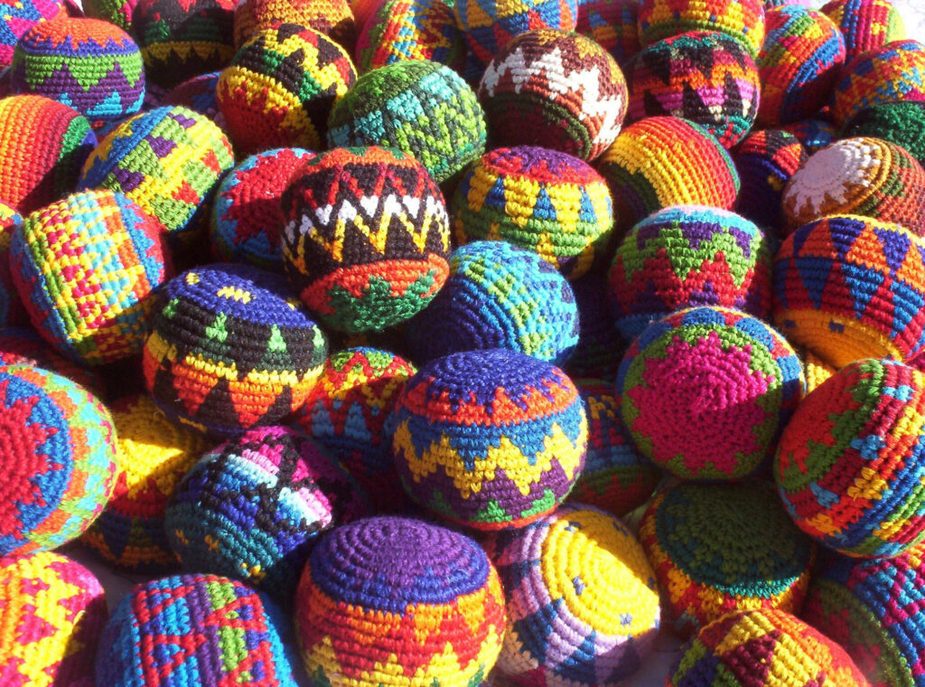 Vibrant Handcrafted Hacky Sack with Indigenous-inspired Crochet Pattern Wallpaper