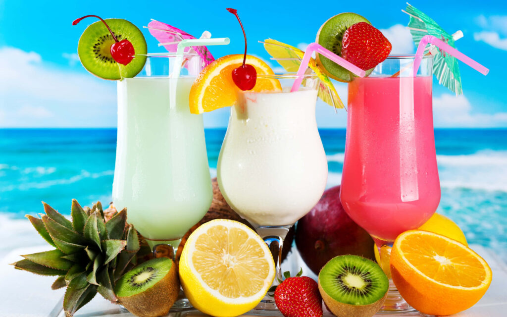 Vibrant Tropical Drinks Wallpaper: Lively Beach Scene & Fresh Fruits