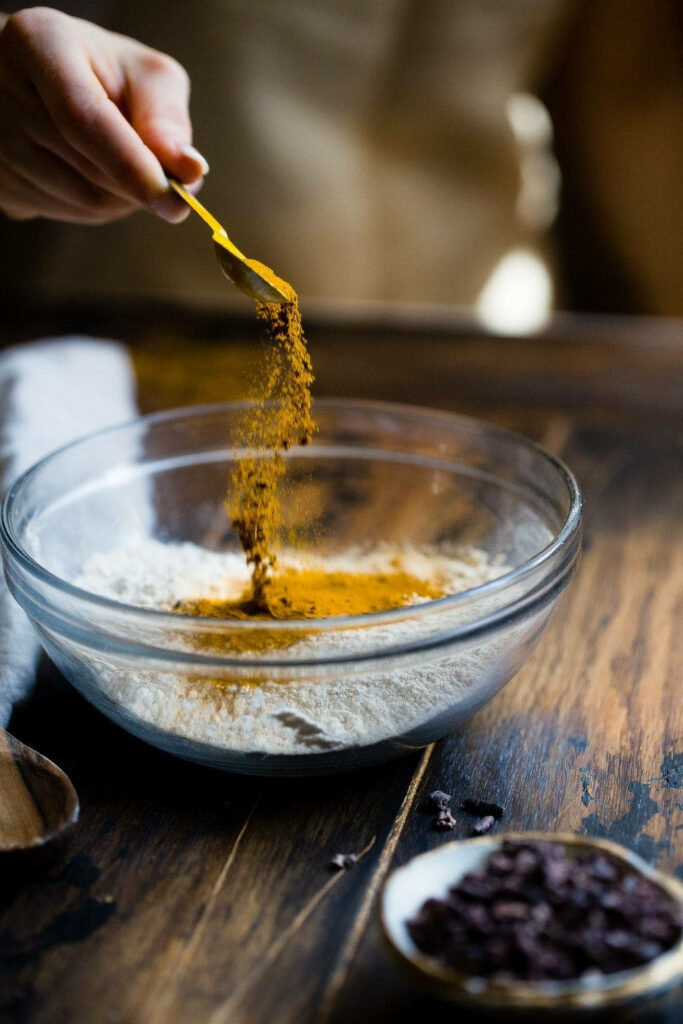 Vibrant Turmeric Powder Wallpaper: Flavorful Seasoning in Flour Bowl