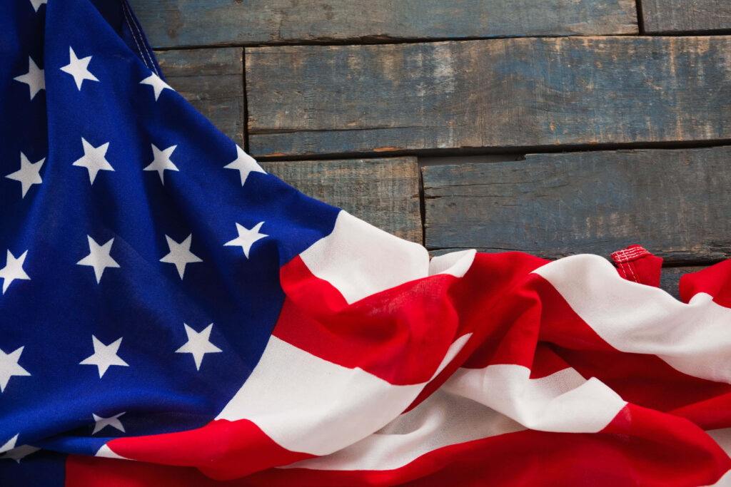Vibrant USA Flag Close-Up: Rustic Wooden Background Wallpaper