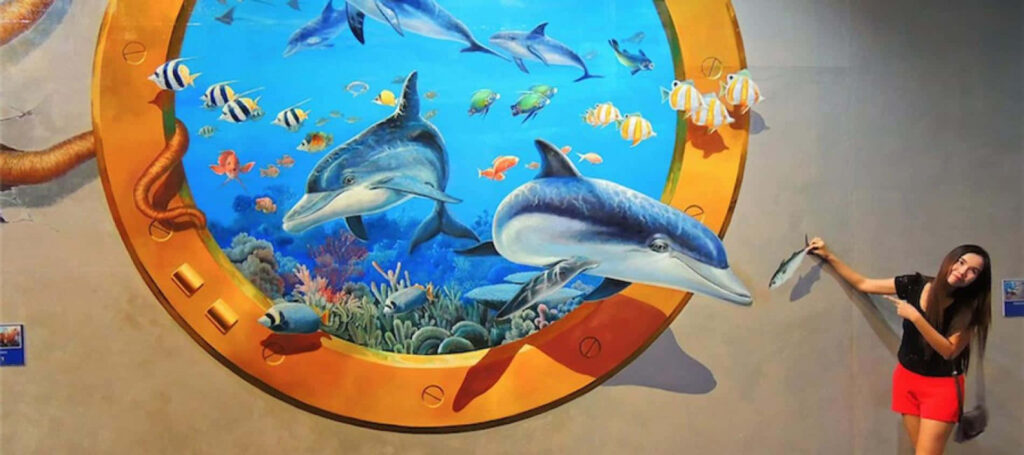 Cheerful Woman by Vibrant Mural of Dolphins and Sea Life Wallpaper