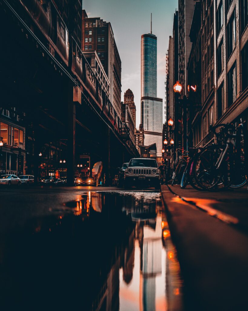 Vibrant Urban Night Scene Wallpaper with Reflective Puddle Background