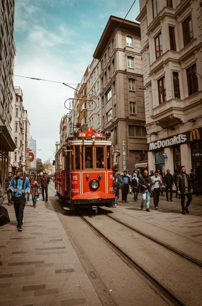 Vibrant Urban Scene: Classic Red Tram & Historic Architecture Wallpaper