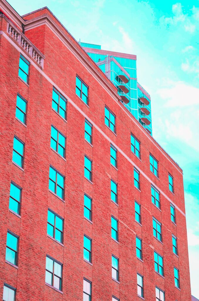 Vibrant Urban Wallpaper: Red Brick Building & Modern High-Rise