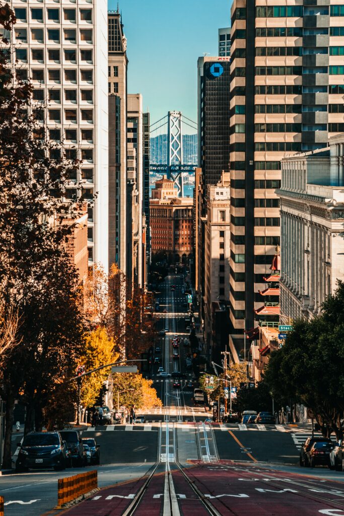 Vibrant Urban Wallpaper: Sloping Road & Towering Buildings