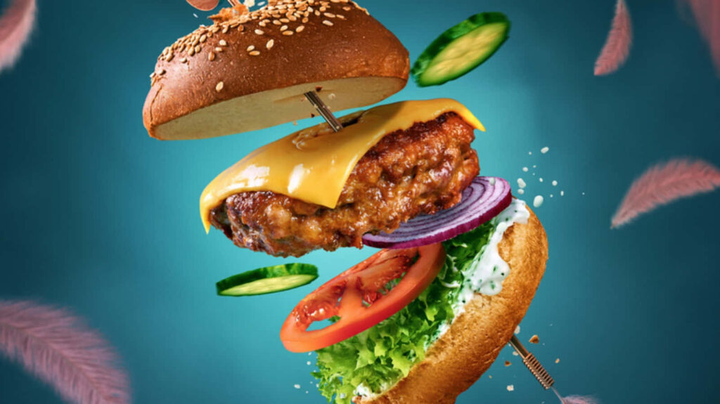 Vibrant Vegan Burger Wallpaper: Plant-Based Delight on Blue Background