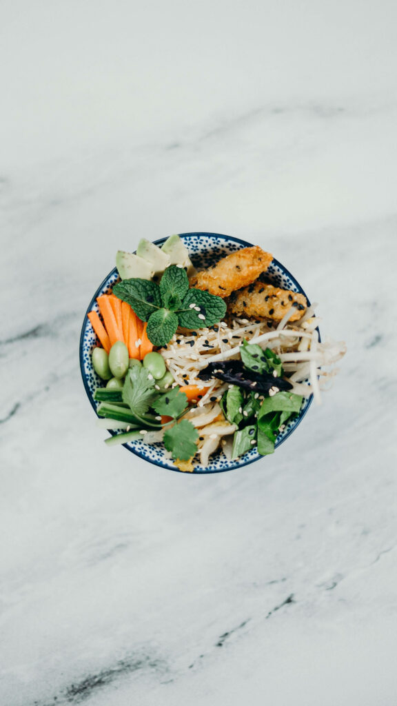 Vibrant Vegetable Bowl on Marble Table: Minimalist Aesthetic Wallpaper