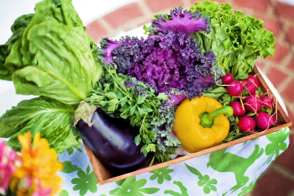 Vibrant Wallpaper: Fresh Veggies in a Basket on Floral Surface