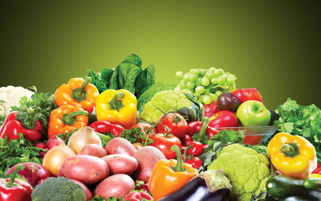 Vibrant Wallpaper of Fresh Fruits & Vegetables on Green Background