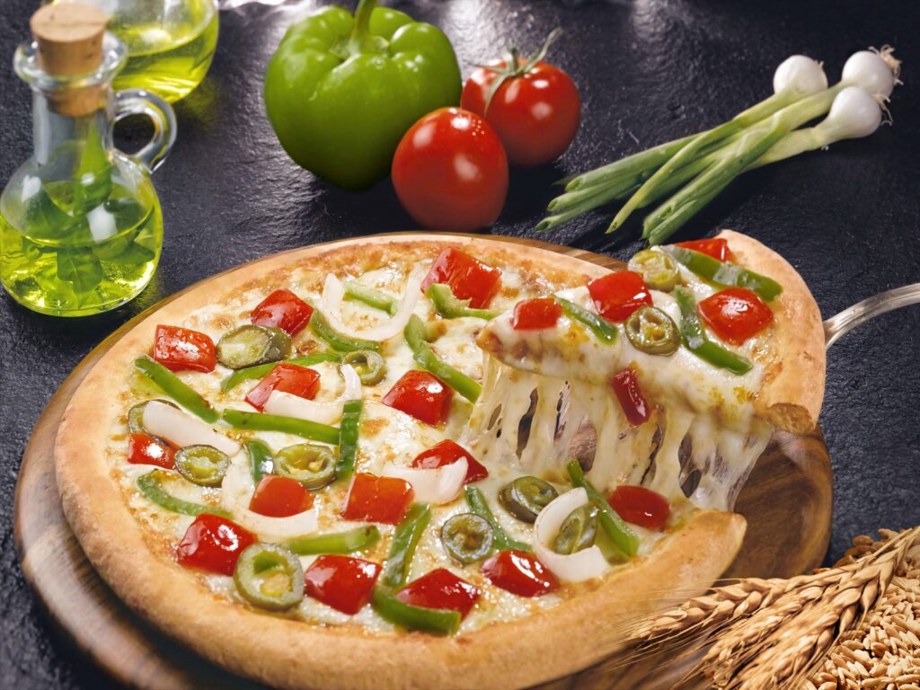 Vibrant Veggie Domino's Pizza with melted cheese fresh peppers tomatoes onions and jalapenos wallpaper