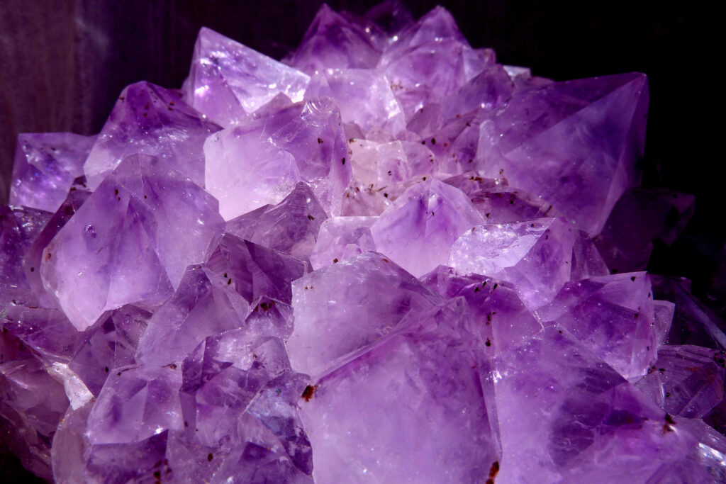Speckled amethyst crystal cluster with vibrant violet hues detailed intricate formations wallpaper