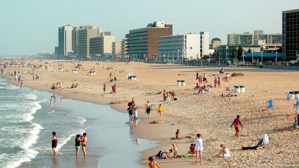 Vibrant Virginia Beach Scene: Sunbathers and Swimmers Enjoying Summer Wallpaper