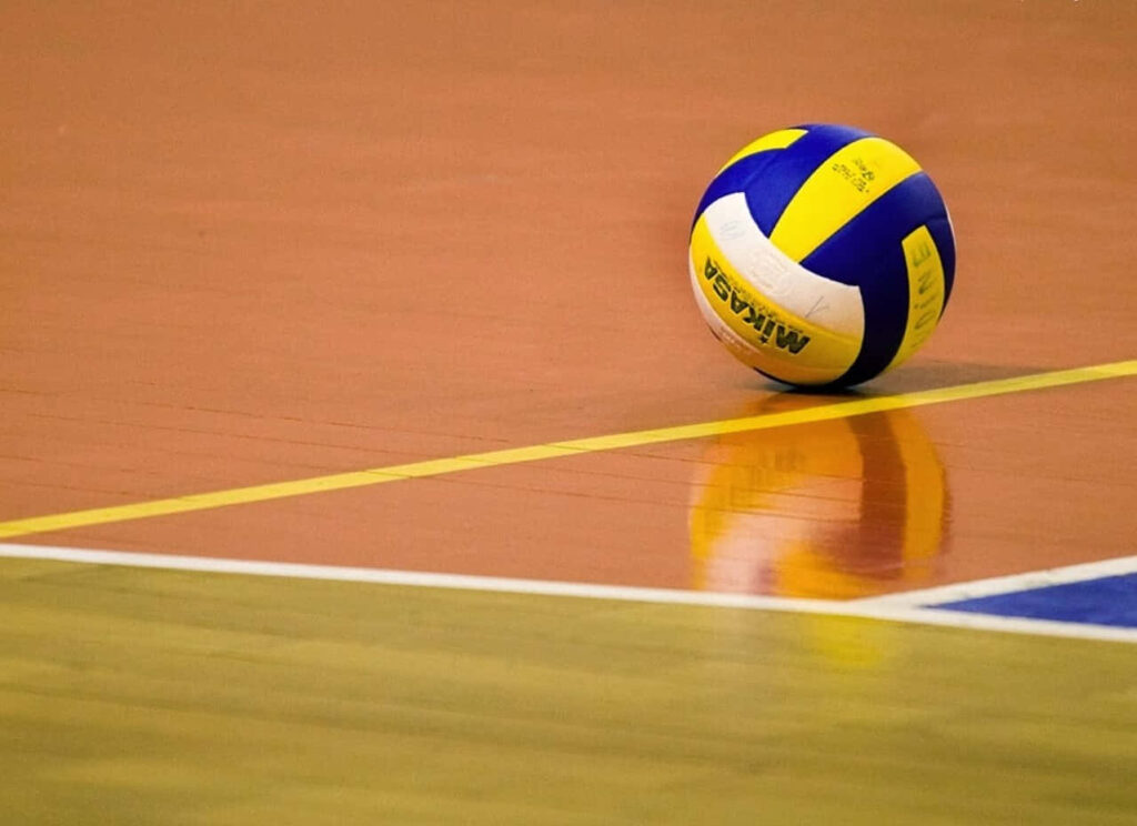 Vibrant Volleyball on Polished Court - Competitive Spirit Wallpaper