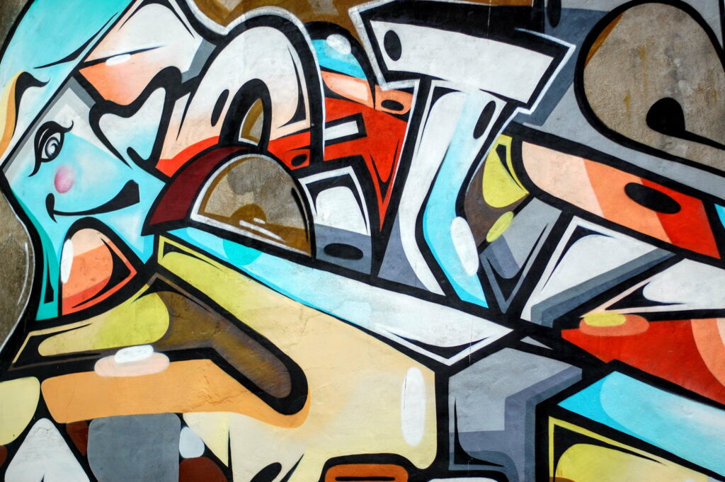 Vibrant Kaleidoscope: A Mesmerizing HD Mural of Multicolored Graffiti Wallpaper