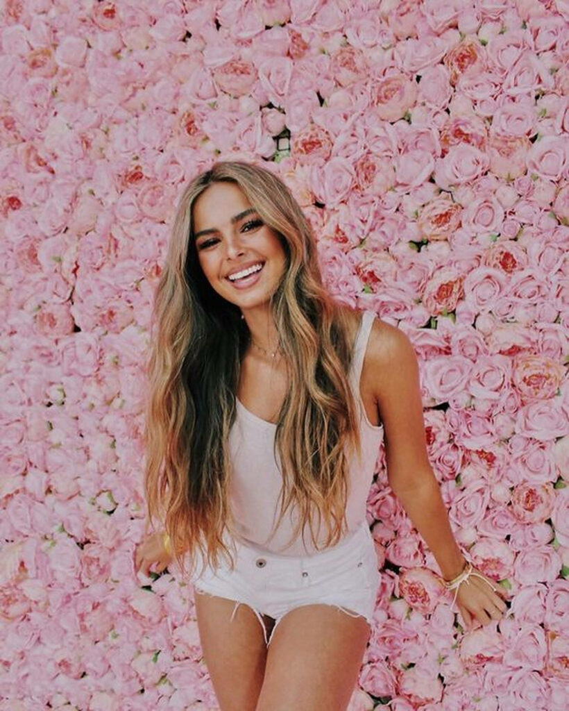 Cheerful Addison Rae in Stylish Floral Wallpaper Background