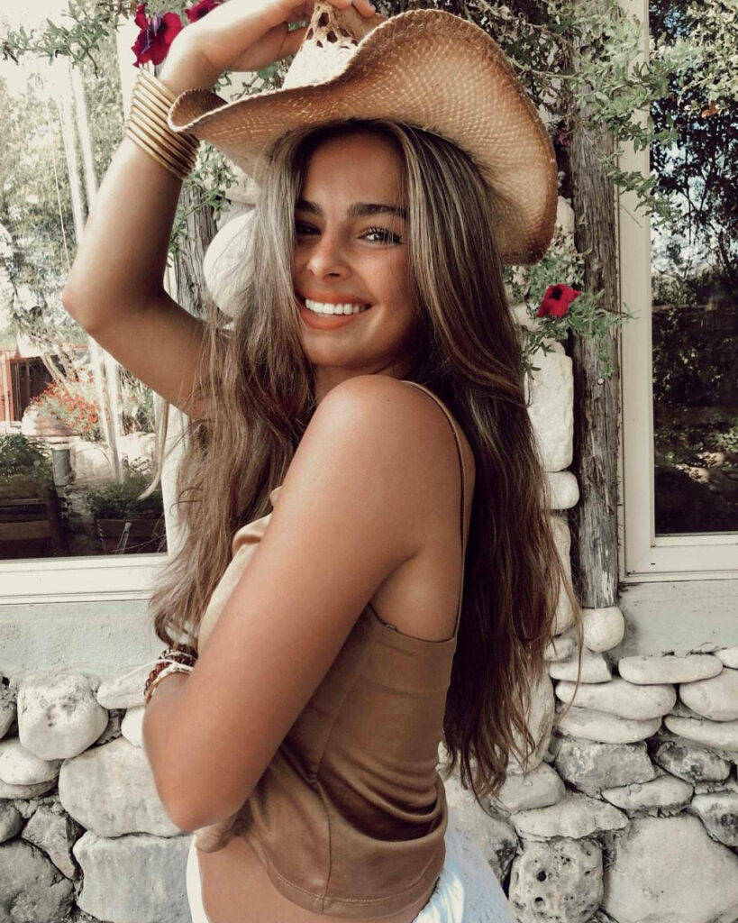 Vibrant Cowboy Hat Wallpaper: Addison Rae's Cheerful Style