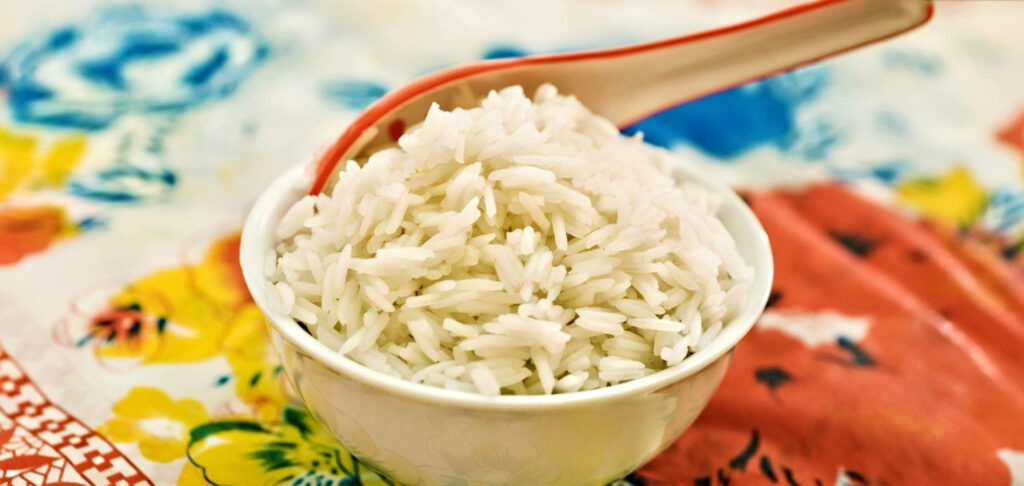 Vibrant Wallpaper: Fluffy Basmati Rice on Floral Tablecloth Background