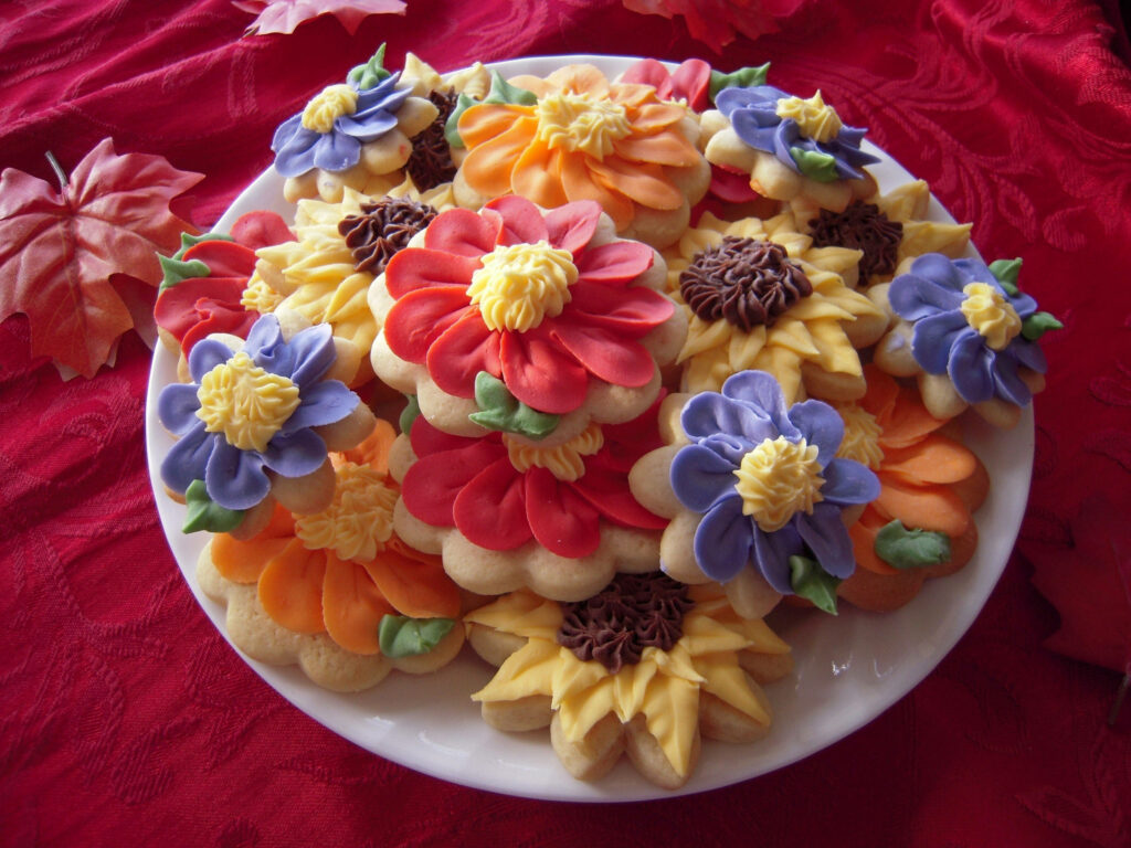 Vibrant Biscuit Wallpaper: Colorful Icing Flowers on Red Background
