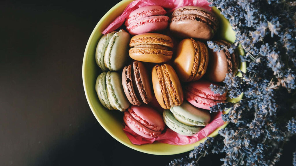 Vibrant Wallpaper: Colorful Macaroons & Floral Accents Display