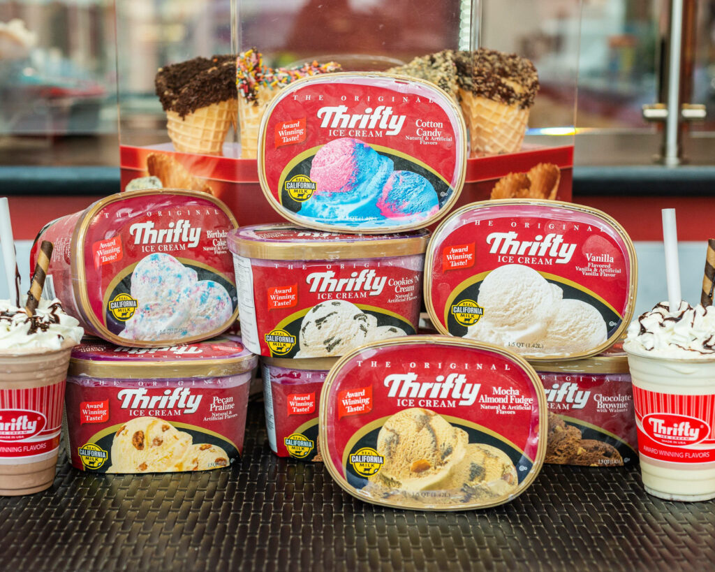 Vibrant Thrifty Ice Cream Tubs Wallpaper Background in Ice Cream Shop