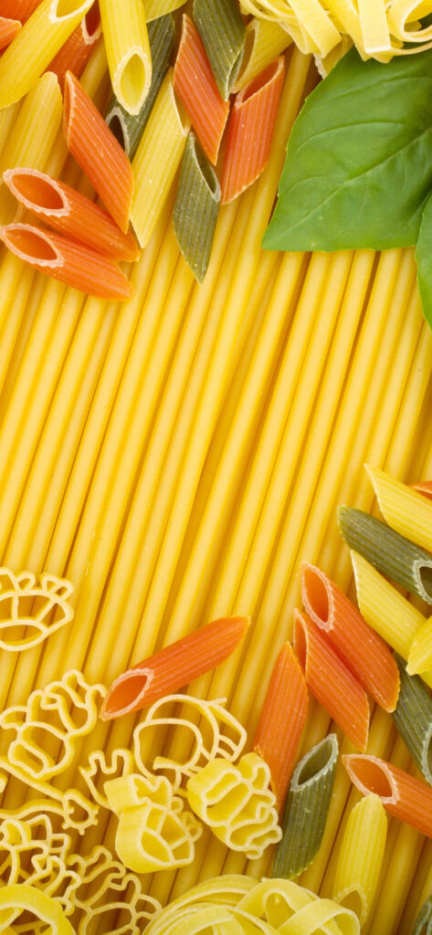 Vibrant Pasta Wallpaper: Colorful Assortment with Fresh Basil